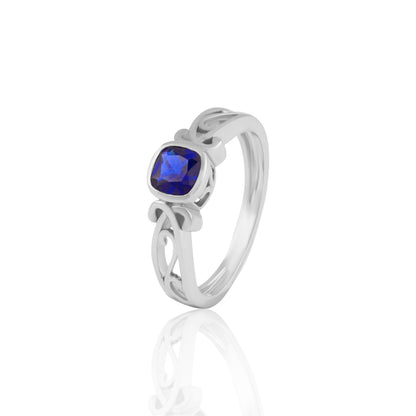 Blue Cushion-Cut Stone Ring with Intricate Openwork Design